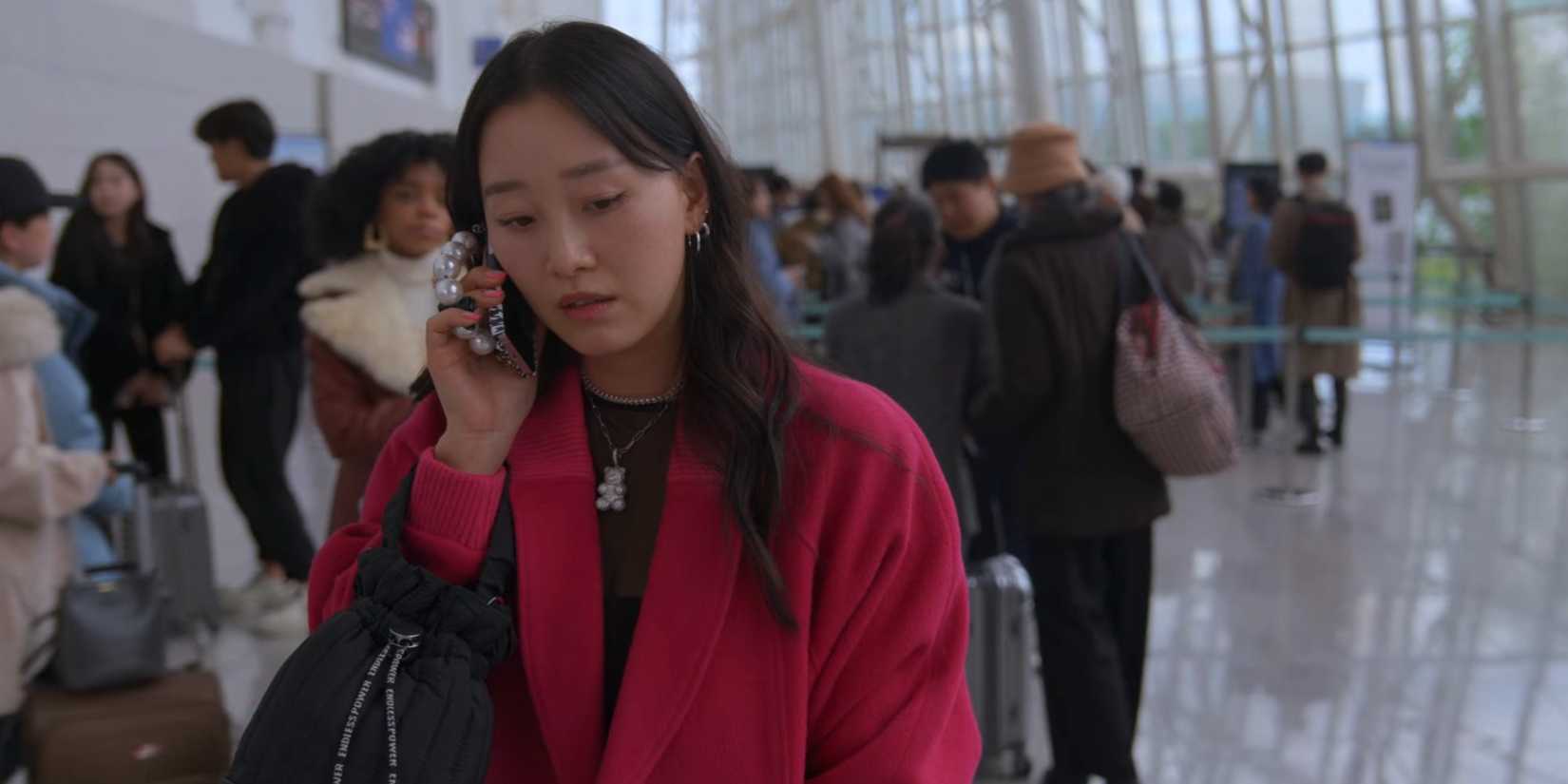 Yuri talks on the phone in the airport in XO Kitty.