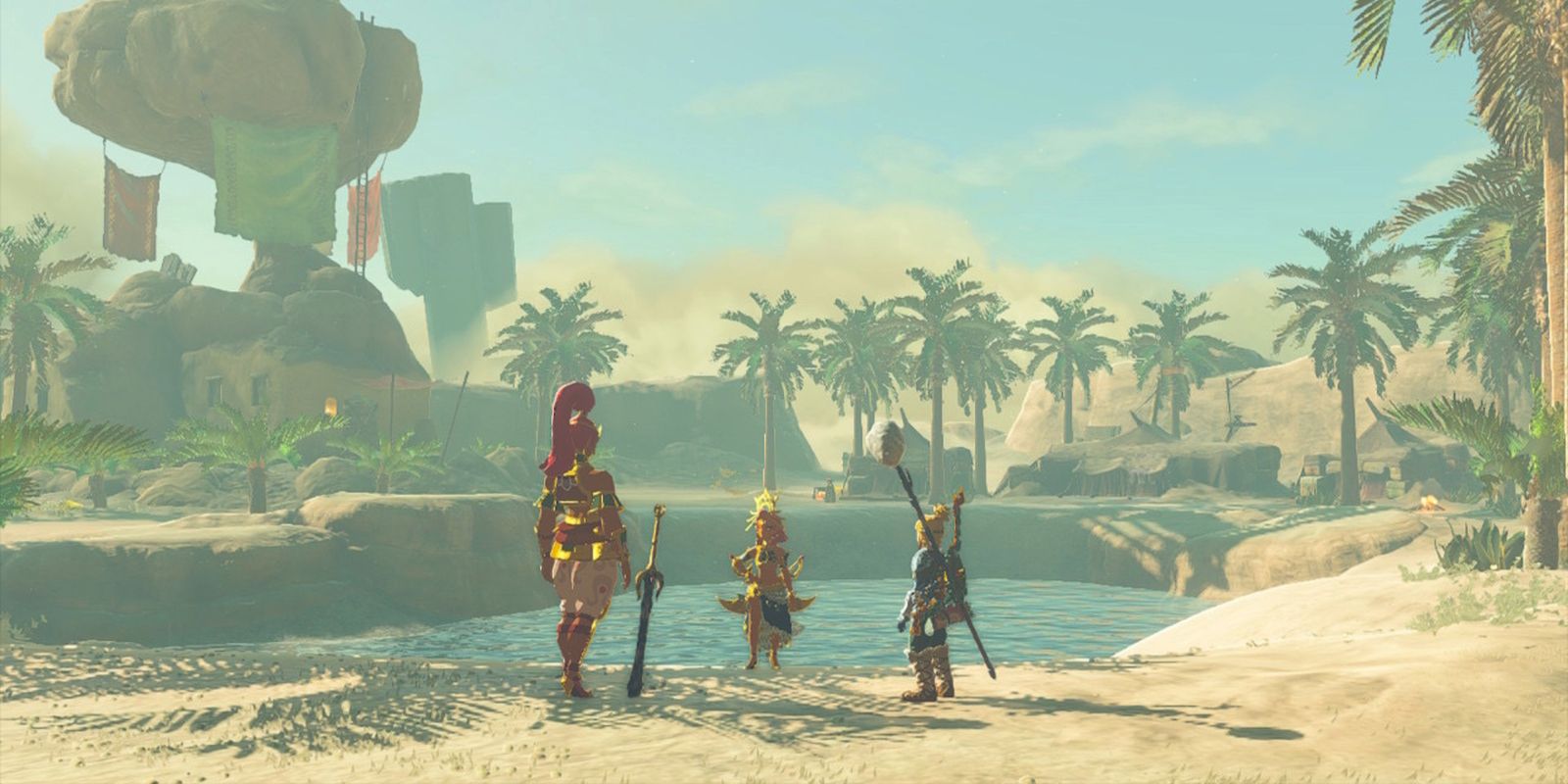 Uno screenshot di Tears of the Kingdom che mostra Buliara, Riju e Link in piedi davanti a uno specchio d'acqua nel deserto di Gerudo.