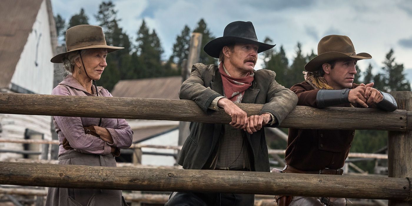 Cara and two cowboys lean on a fence in 1923