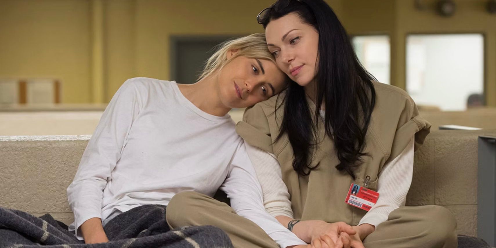 Piper Chapman (Taylor Schilling) with her head on Alex Vause's (Laura Prepon) shoulder in Orange is the New Black