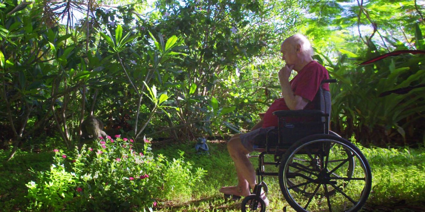 A still of Ram Dass in a wheelchair in Ram Pass, Going Home