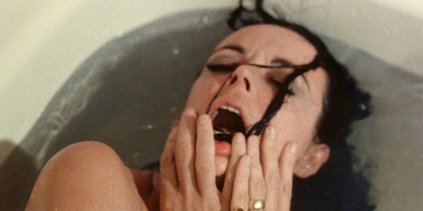 A woman puts her hands on her face while soaking in the bathtub in Shivers (1975).