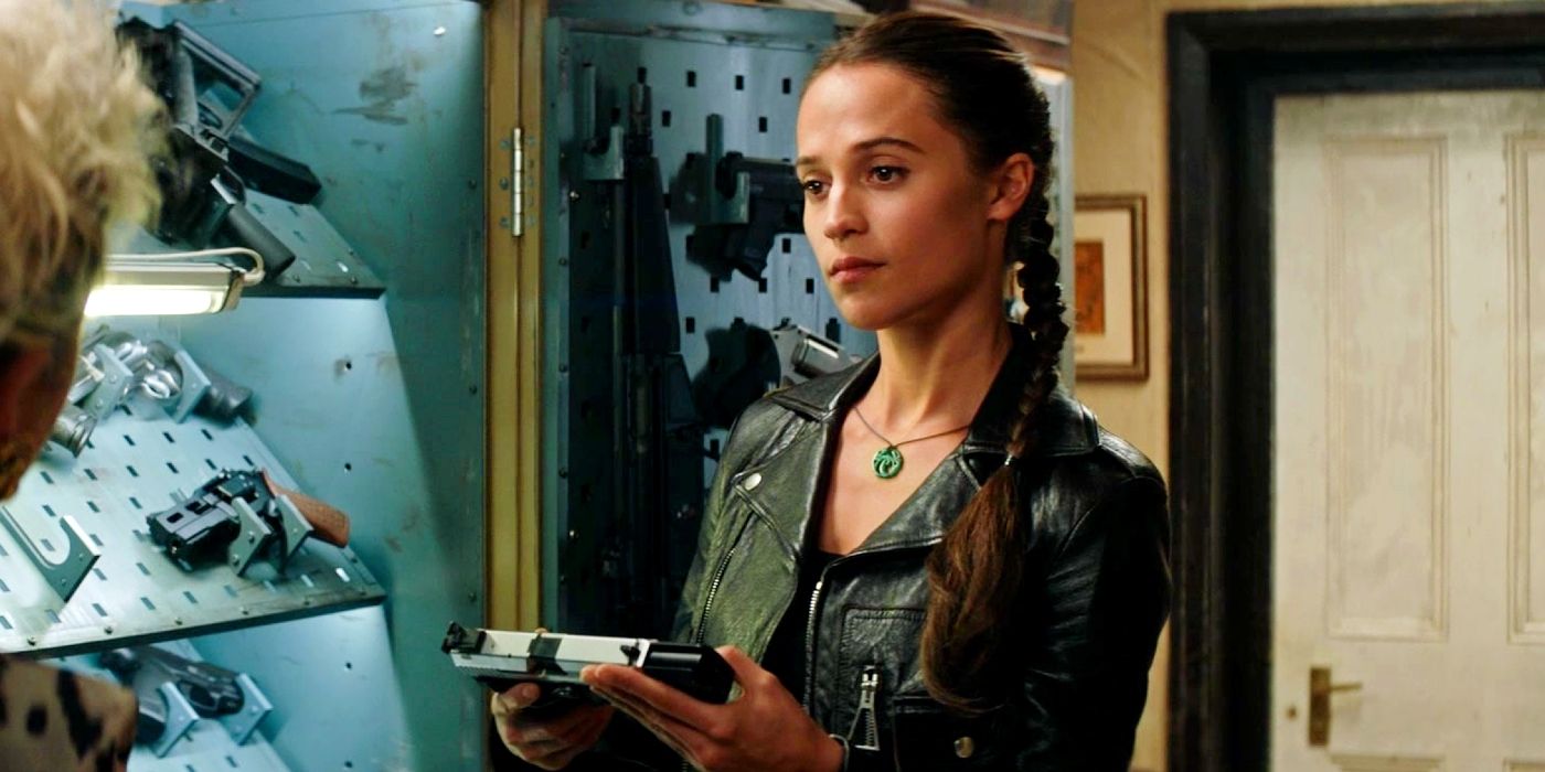 Alicia Vikander holding a pistol in Tomb Raider.
