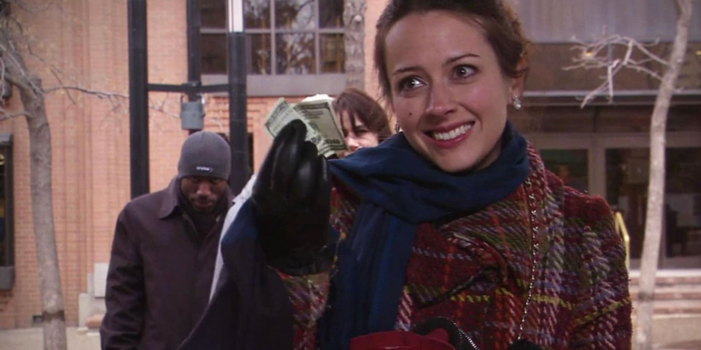 Amy Acker holding onto money in Dear Santa