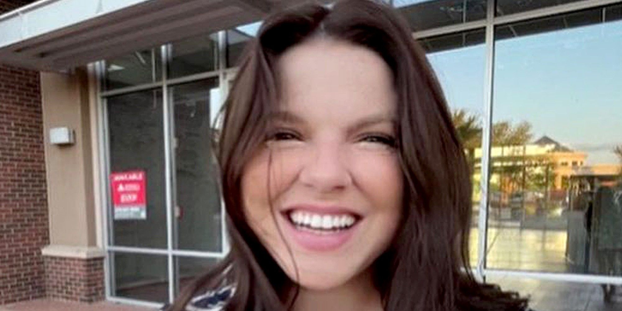 amy duggar kind 19 kids and counting smilng outside of a stroefront