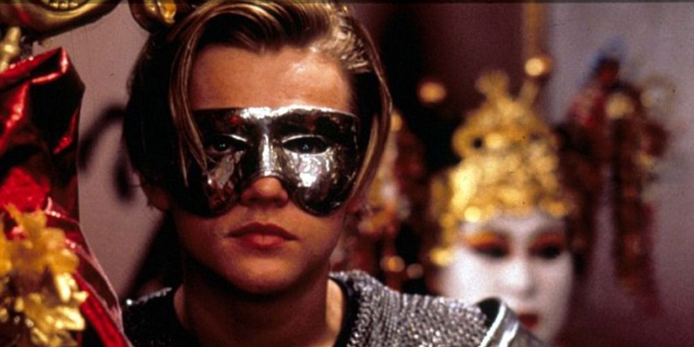 An image of Romeo wearing a costume and mask in the 1996 movie.