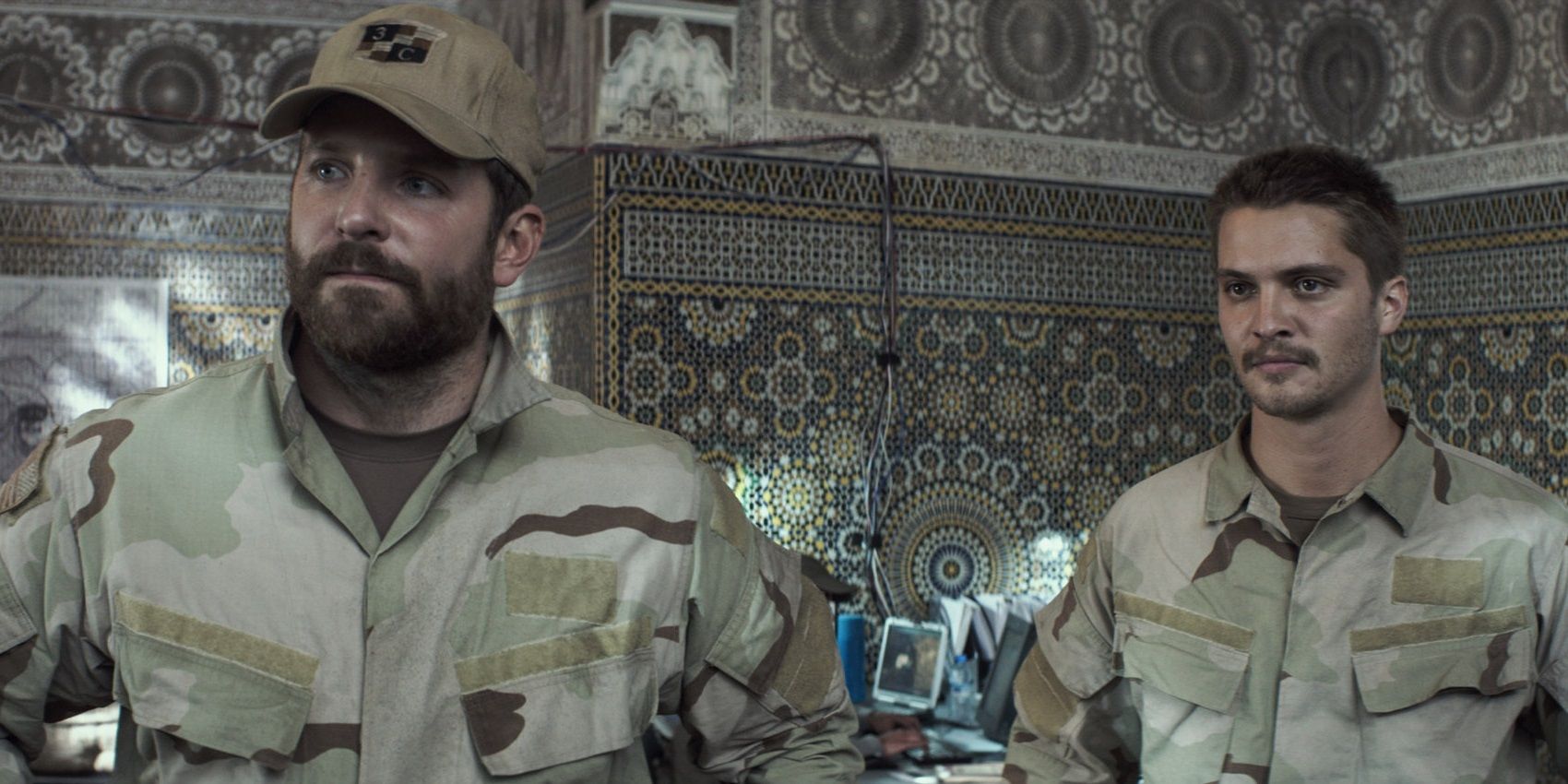 Bradley Cooper and Luke Grimes in military uniform in American Sniper