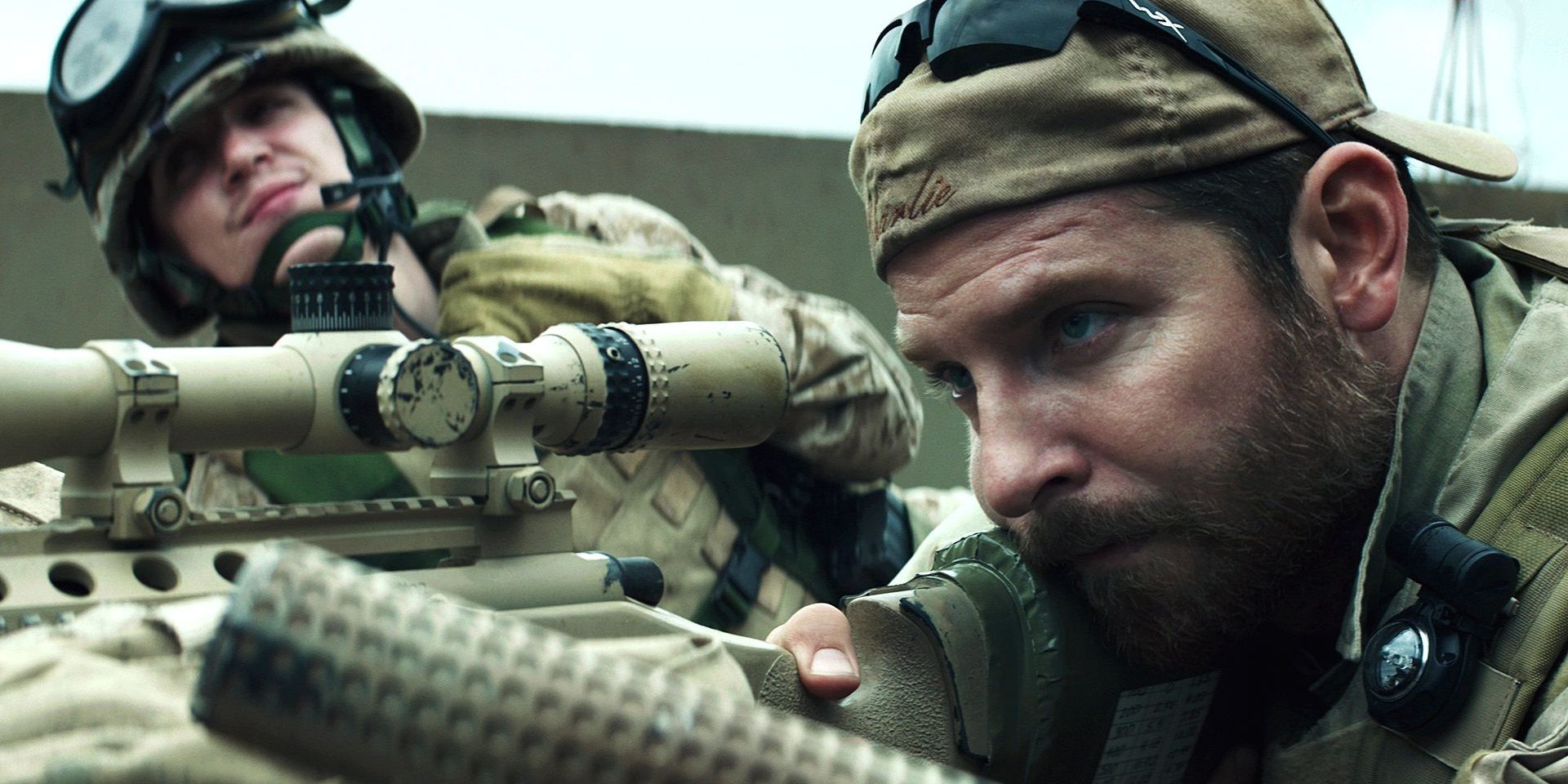 Bradley Cooper looking down a scope in American Sniper