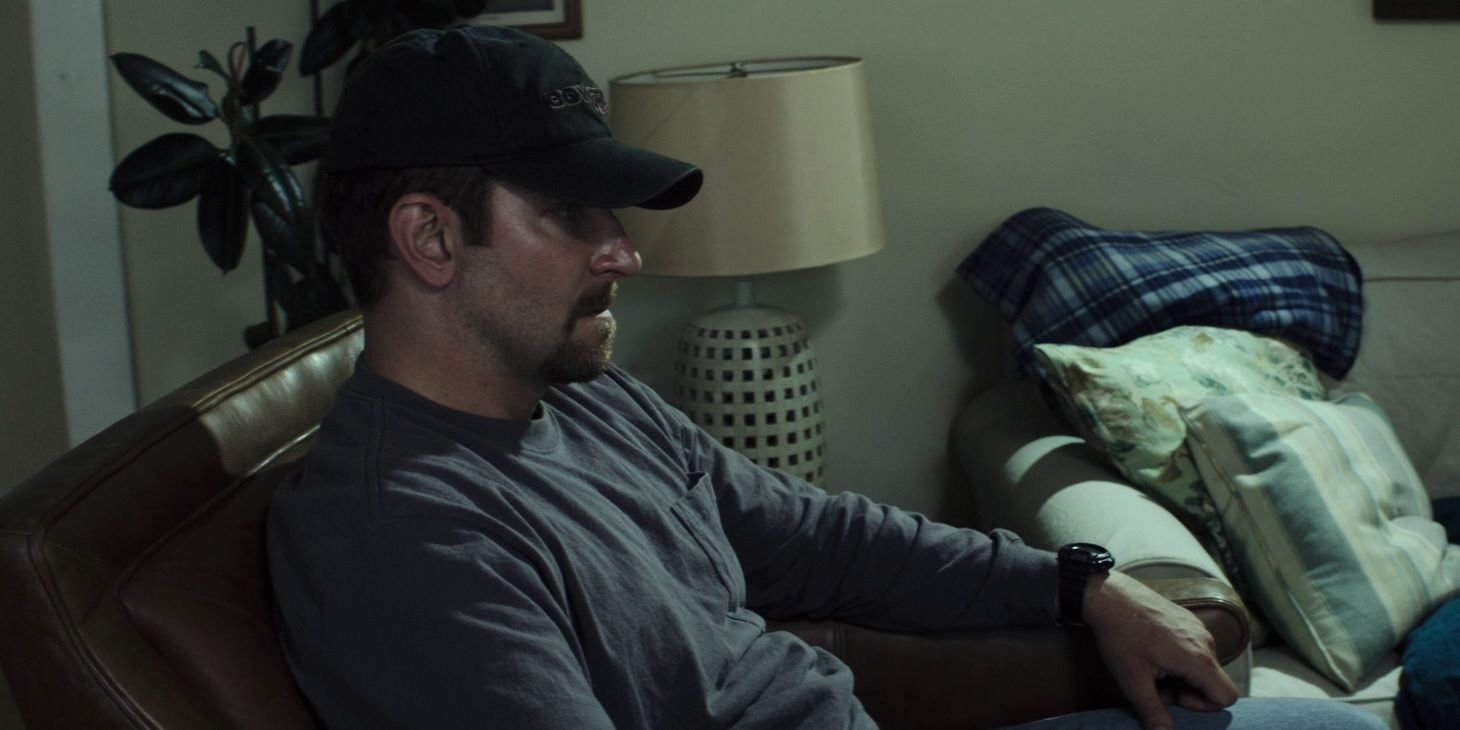 Bradley Cooper sitting in a chair in American Sniper
