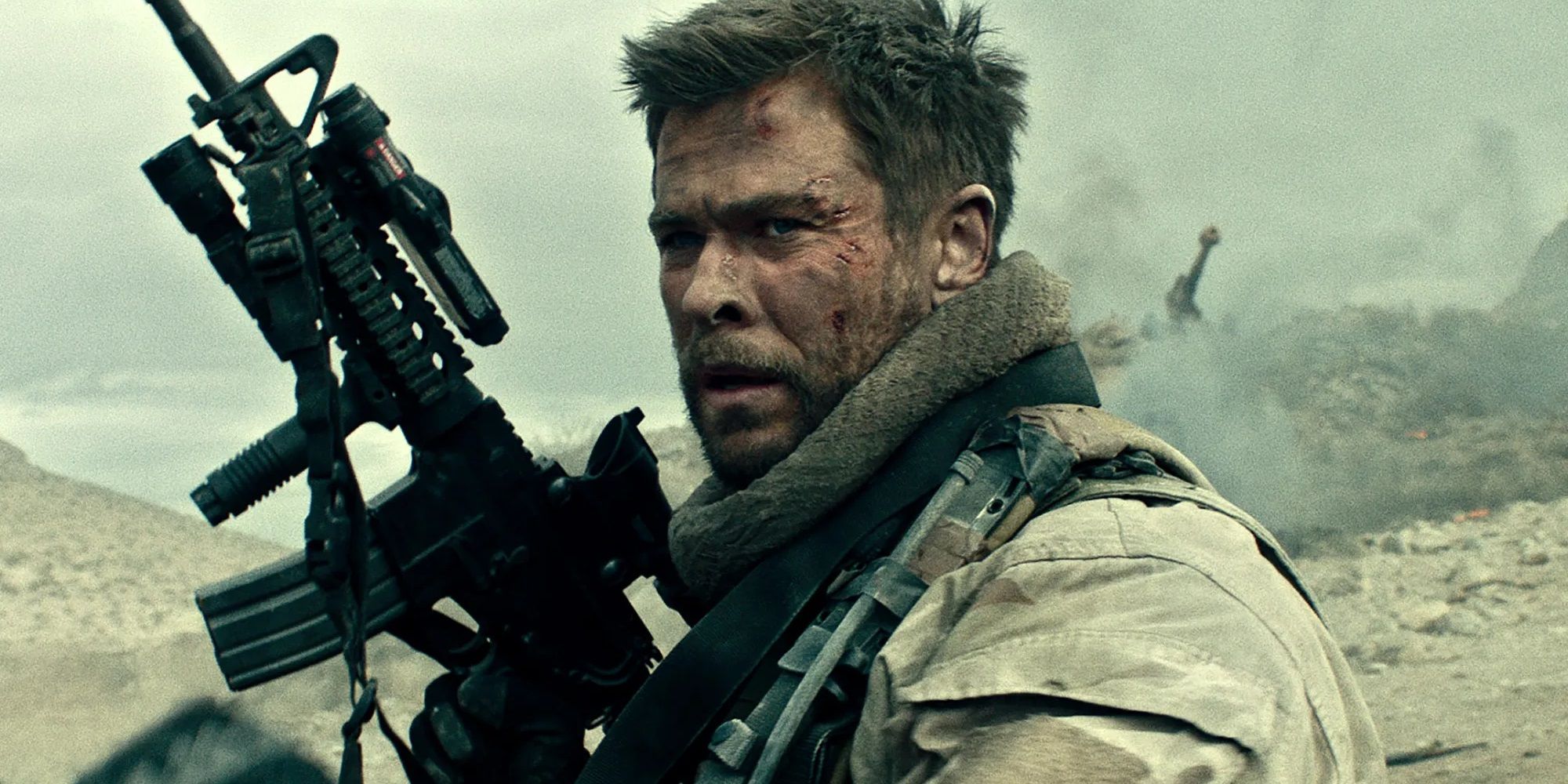 Chris Hemsworth with a machine gun in 12 Strong