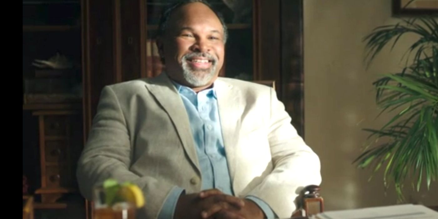 Geoffrey Owens wearing a suit and grinning
