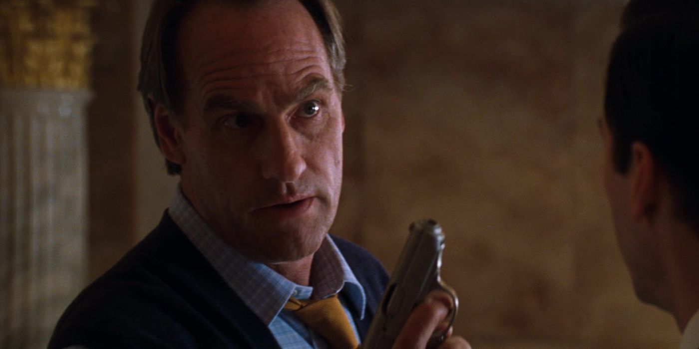 Craig T. Nelson holding a gun in The Devil's Advocate.