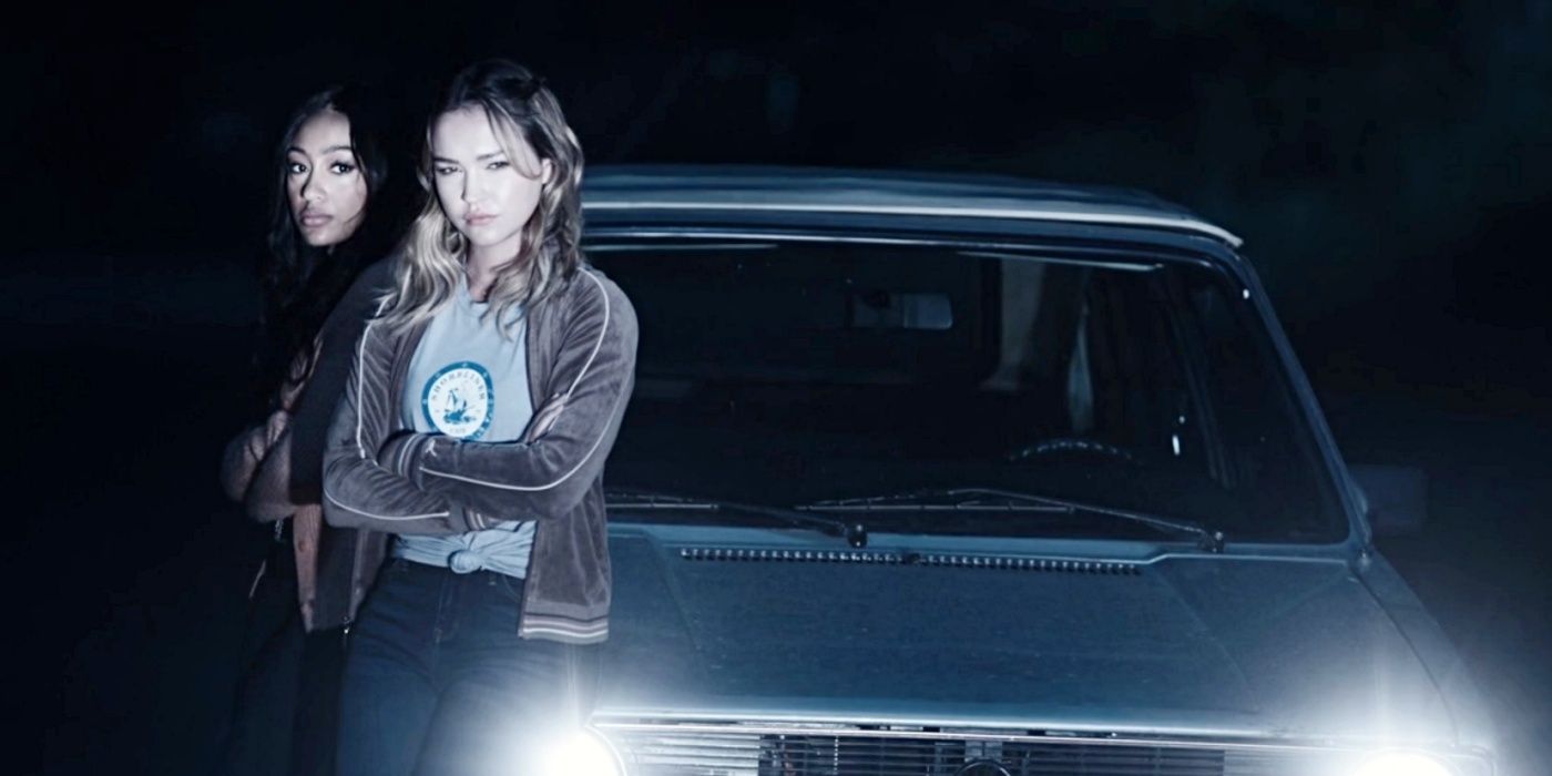 Isabella and Megan lean against a car in Cruel Summer season 2, episode 3.