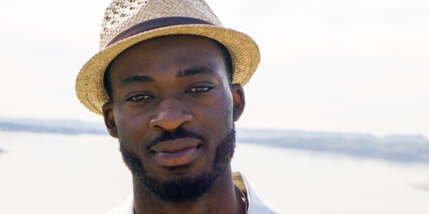Dotun Olubeko The Bachelorette wearing hat smiling white background