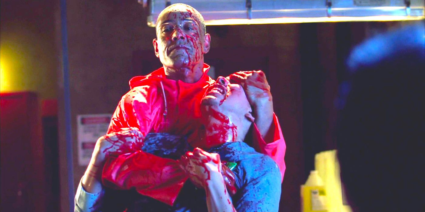 Giancarlo Esposito as Gus Fring in Breaking Bad wearing a red plastic poncho while clutching a helpless man, both of them covered in blood