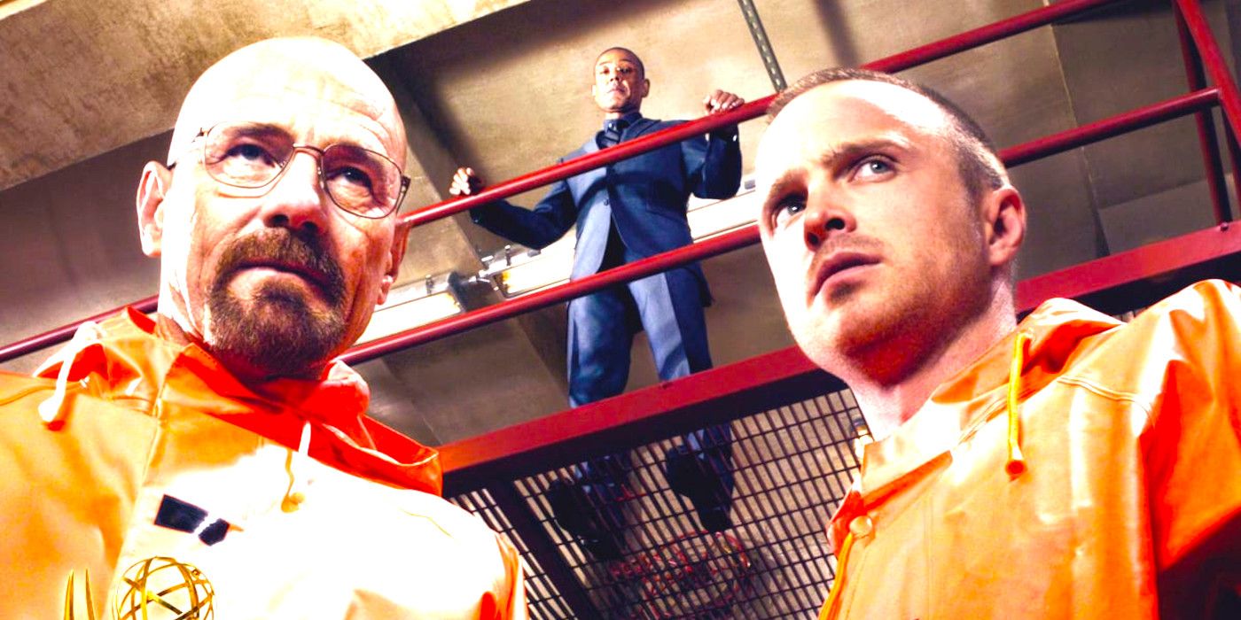 Giancarlo Esposito in Breaking Bad, in a suit on a catwalk, gazing down menacingly on Bryan Cranston and Aaron Paul who are both wearing red plastic ponchos