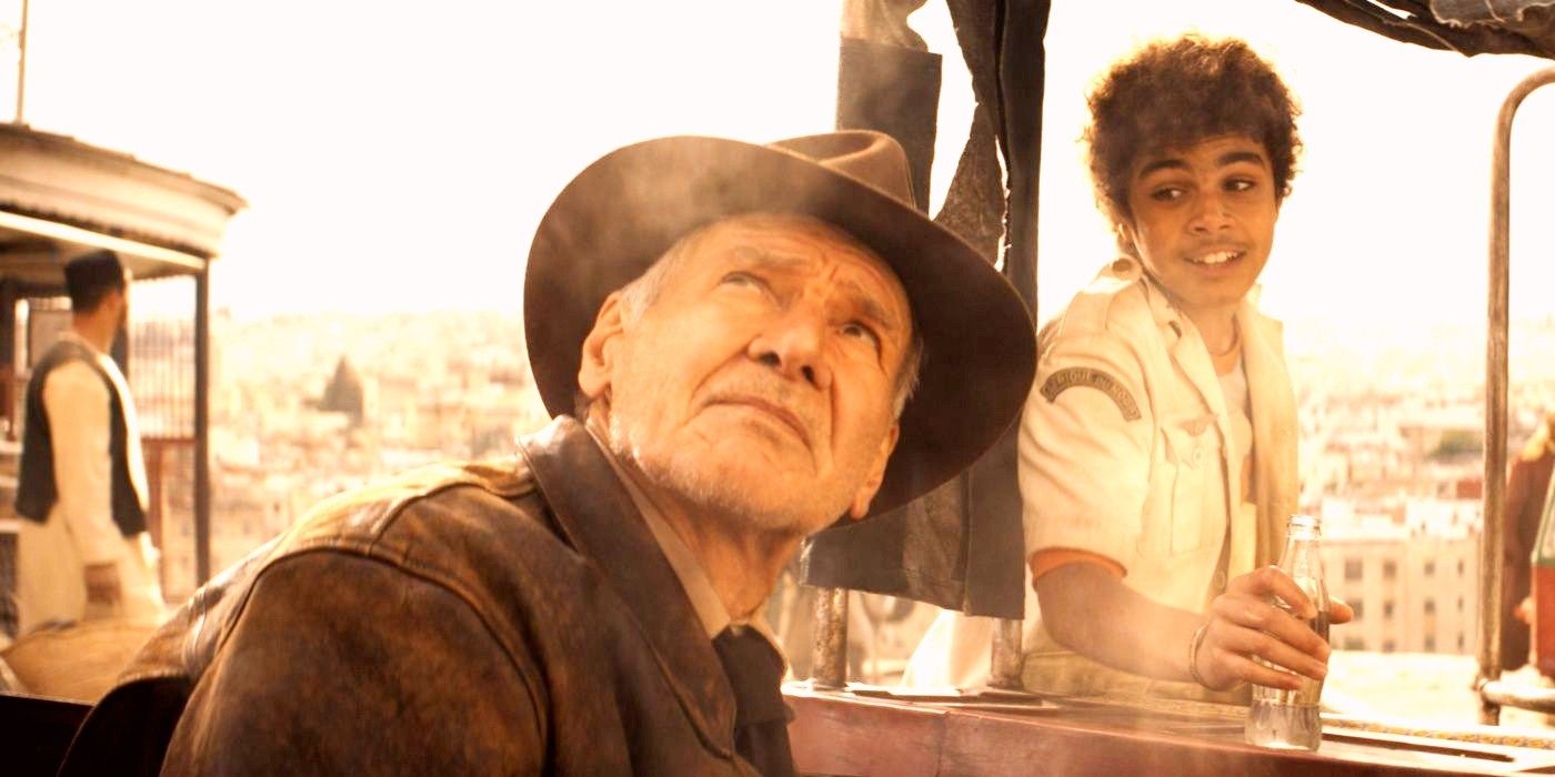 Harrison Ford as Indiana Jones looking up as Teddy smiles behind him