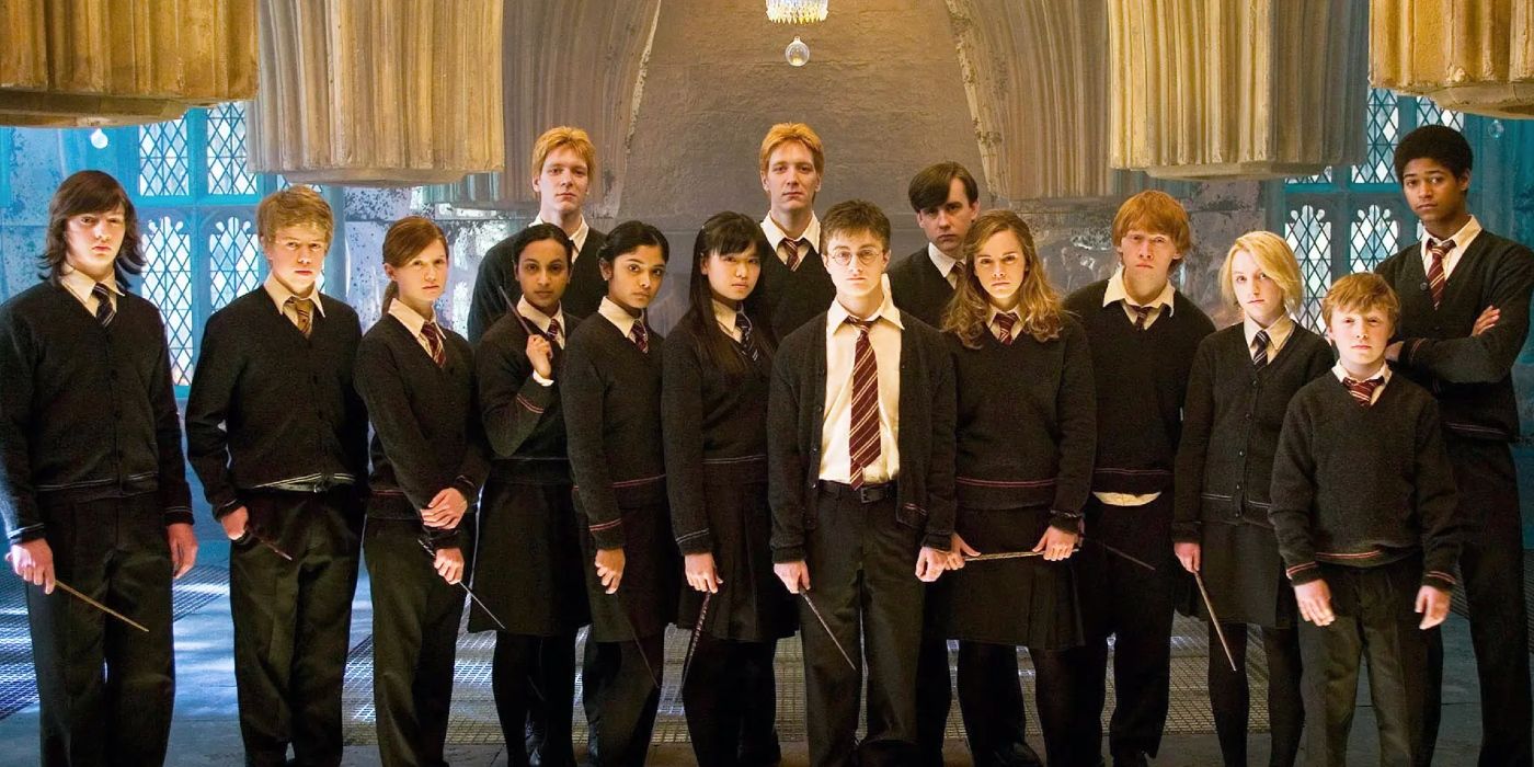 Daniel Radcliffe, Rupert Grint, and Emma Watson as Harry, Ron, and Hermione pose with members of Dumbledore's Army in Harry Potter 5.