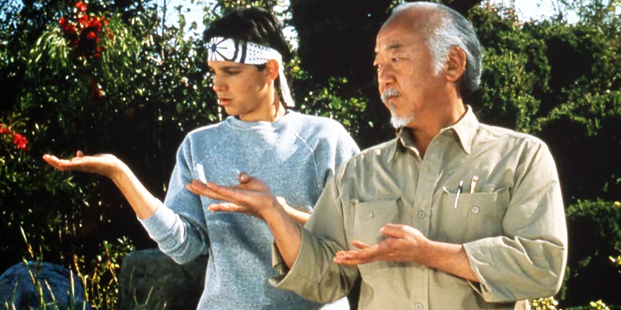 Mr. Miyagi training Daniel LaRusso in The Karate Kid
