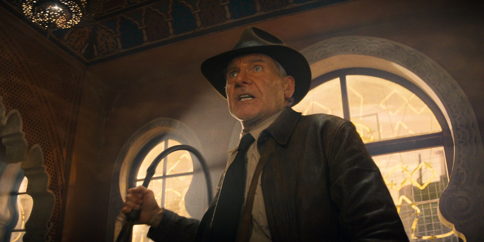 Indiana holding his whip in Indiana Jones and the Dial of Destiny