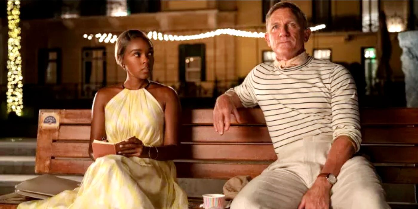 Helen (Janelle Monáe) and Benoit (Daniel Craig) sitting on a bench together in Glass Onion: A Knives Out Mystery.