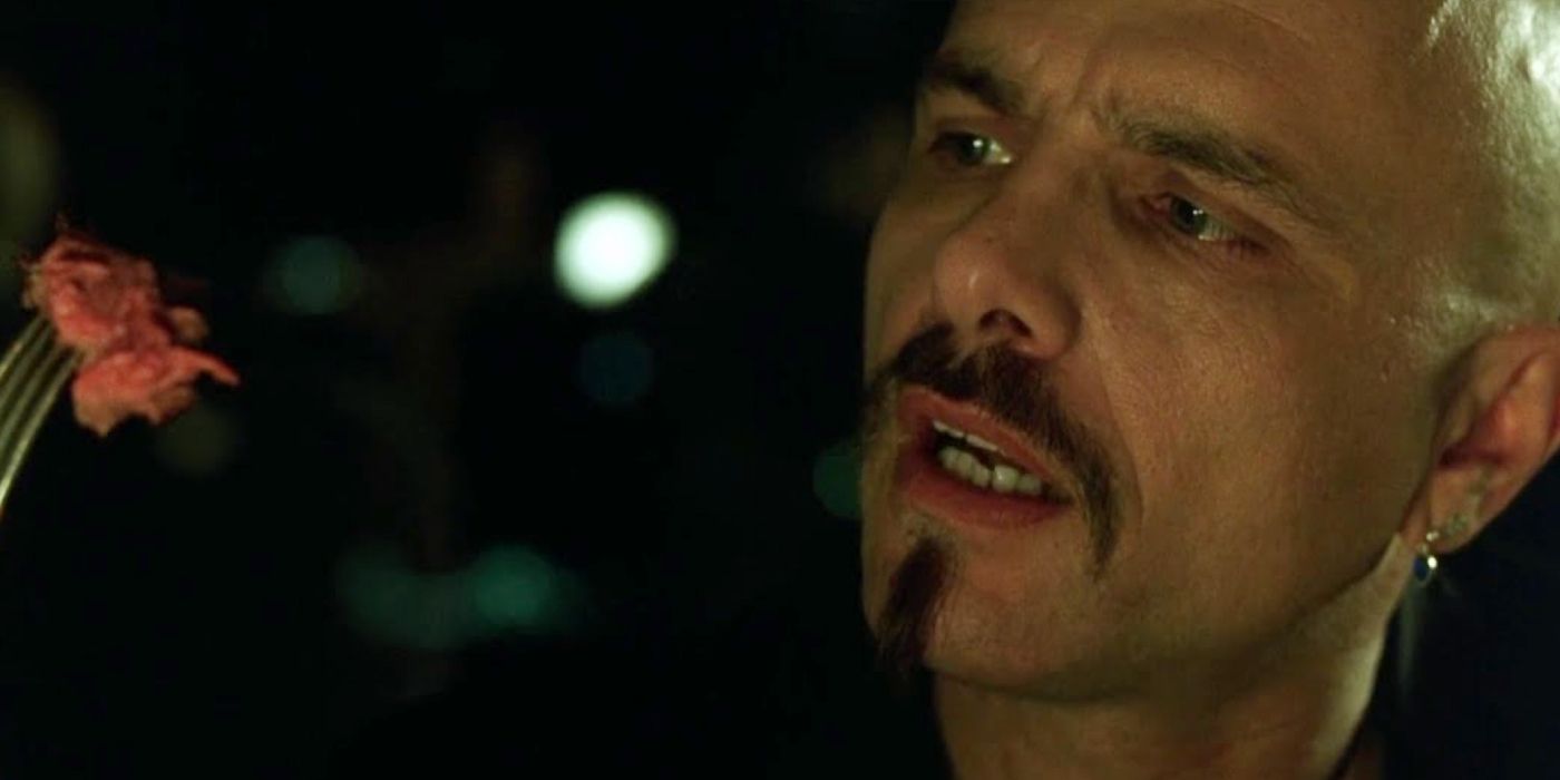 Joe Pantoliano as Cypher looking at steak in The Matrix.