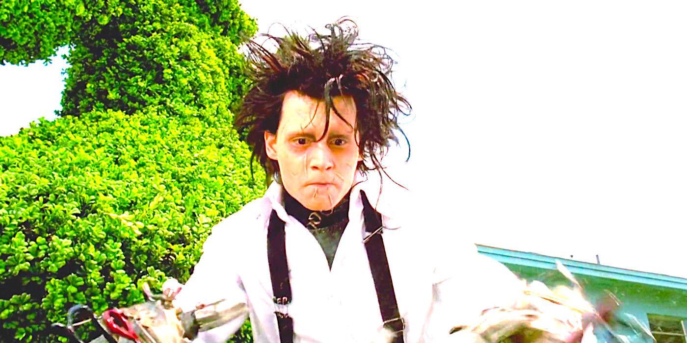 Johnny Depp as Edward Scissorhands with wild flyaway black hair and pale, scarred face, working intently with his flashing scissor hands.