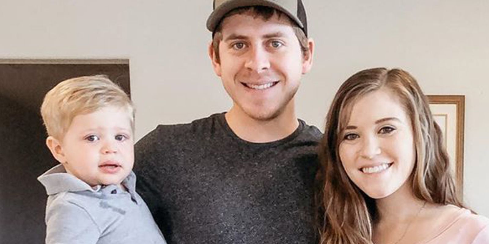 Joyanna Duggar smiling with her husband and child 