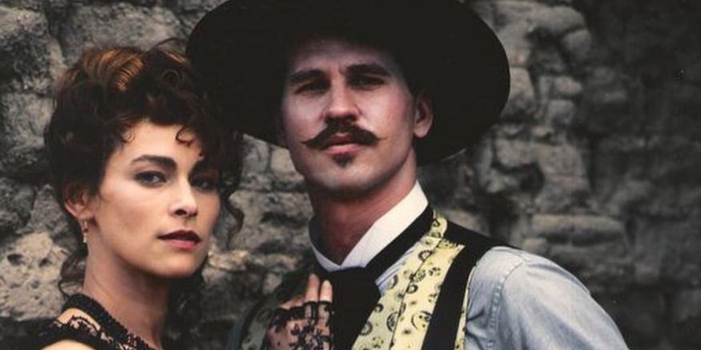 Kate and Doc Holliday posing by a rock wall in Tombstone