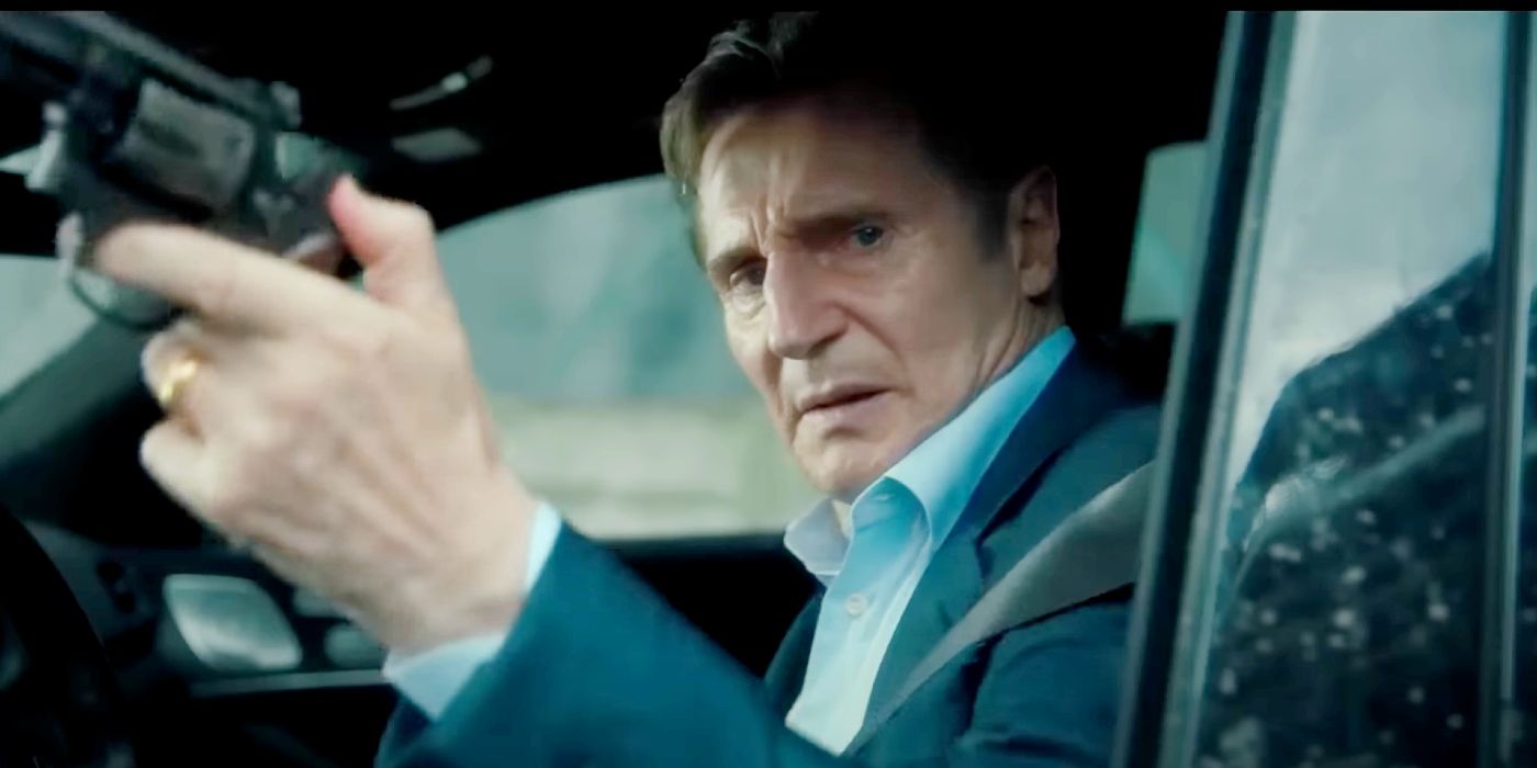 Liam Neeson sitting in a car and holding a gun in Retribution.