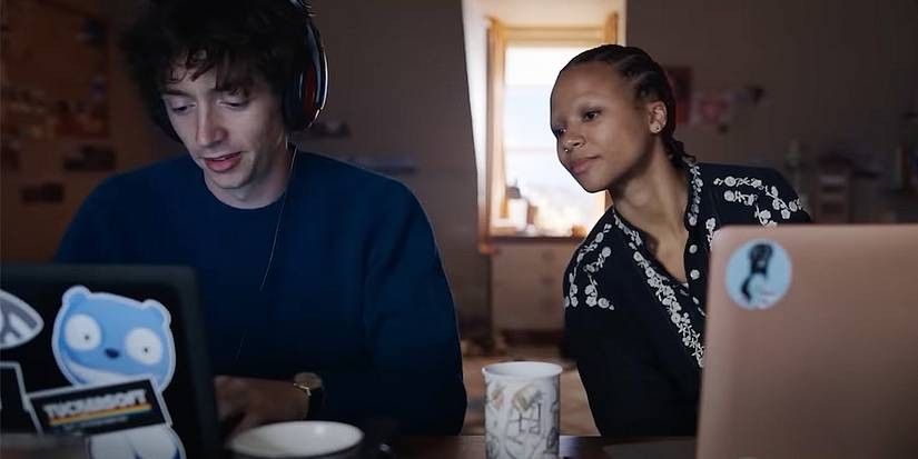 Davis and Pia on laptops in Black Mirror episode Loch Henry.