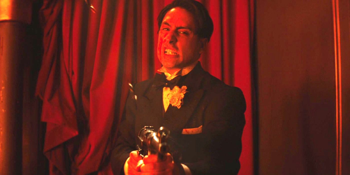 A tuxedo-wearing man with a machine gun making a furious face as he pumps bullets into someone