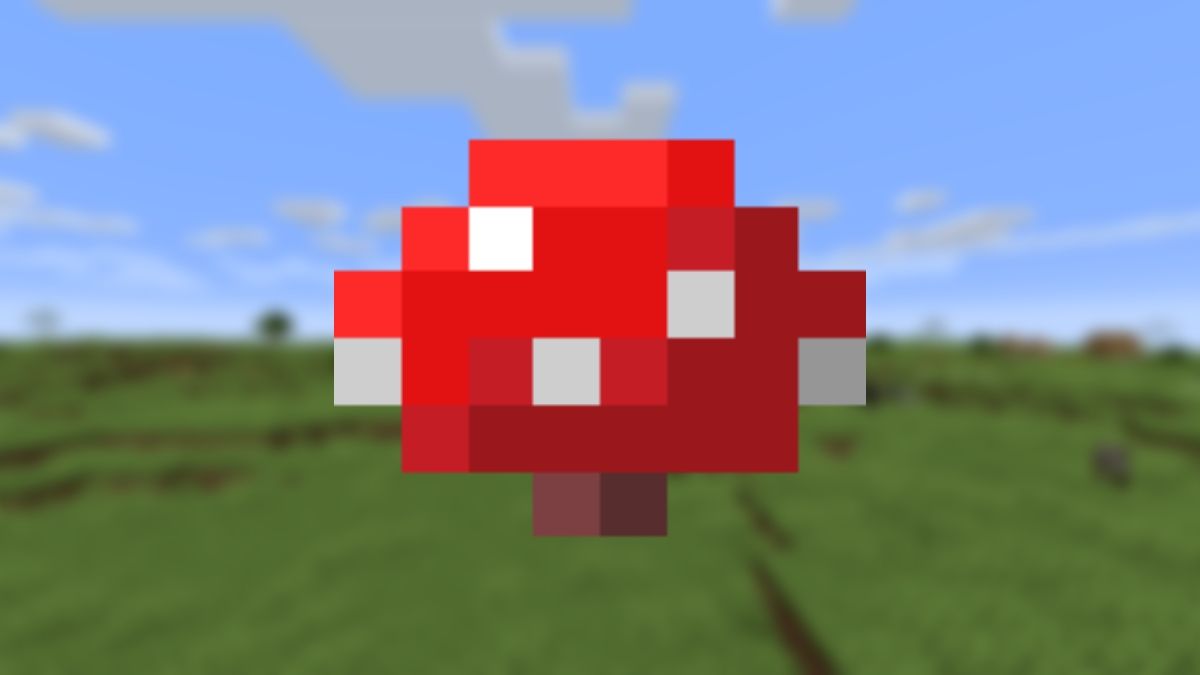 View of a red mushroom with white spots on a blurry background of some plains in Minecraft