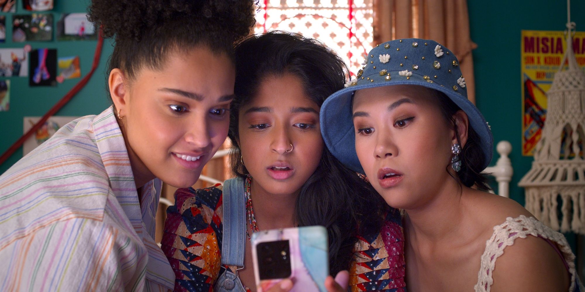 Fabiola, Devi and Eleanor looking at a phone in Never Have I Ever Season 4