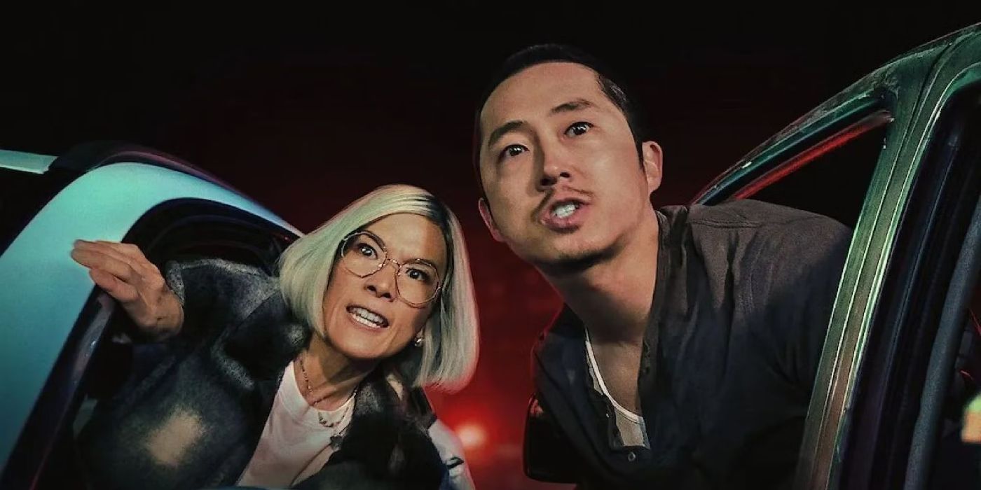 Danny (Steven Yeun) and Amy (Ali Wong) in Beef leaning out of their cars.