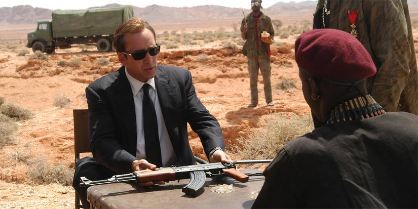 Nicolas Cage sits with a machine gun in Lord of War