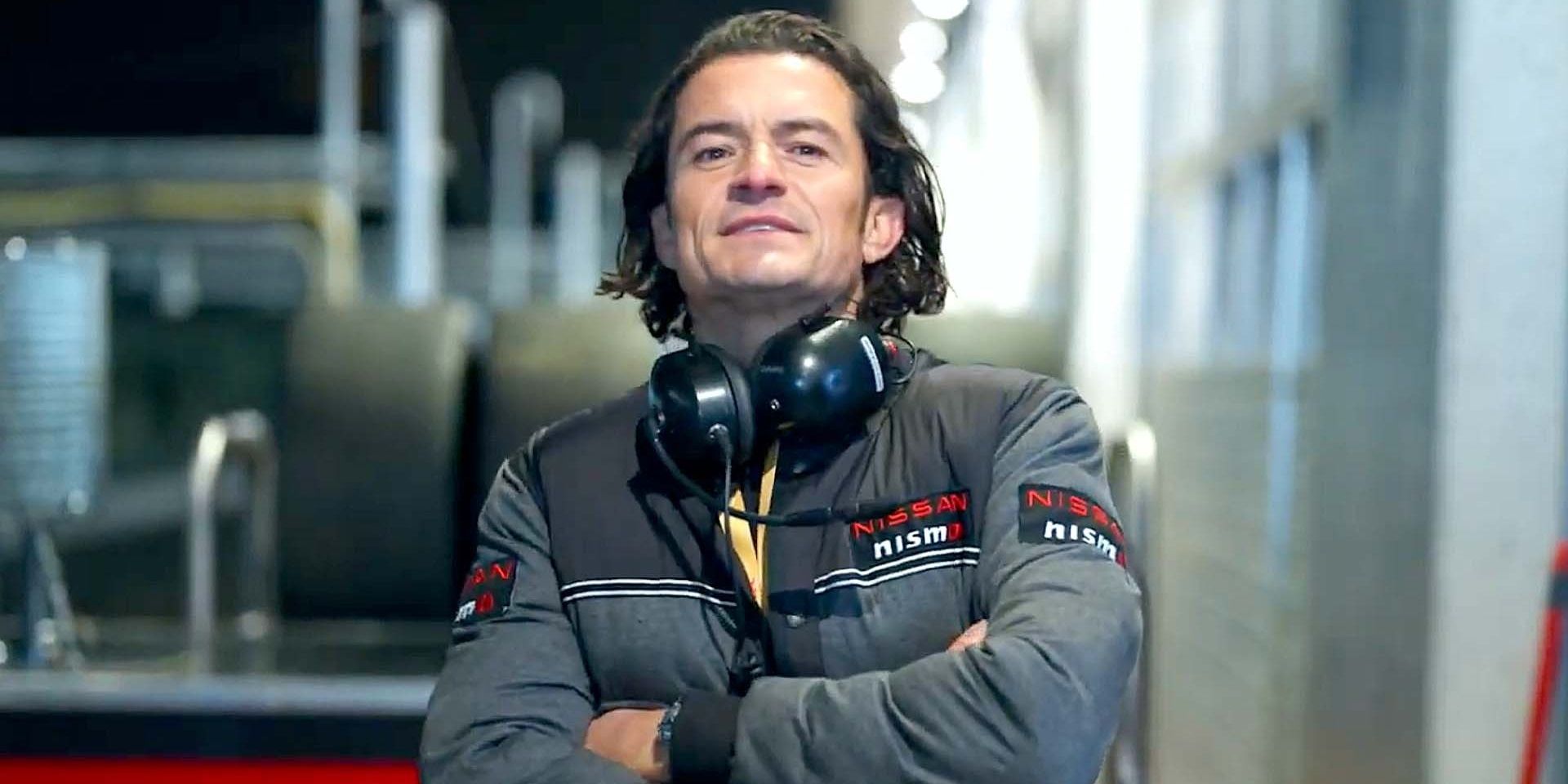 Orlando Bloom with his arms crossed in Gran Turismo