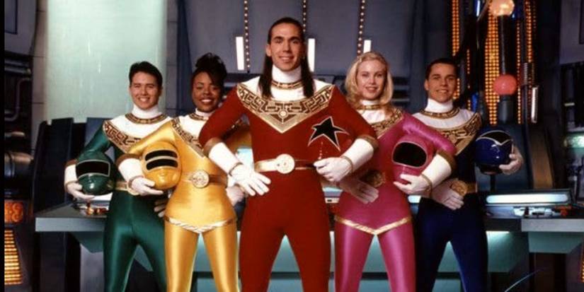 The cast of Power Rangers Zeo holding their helmets