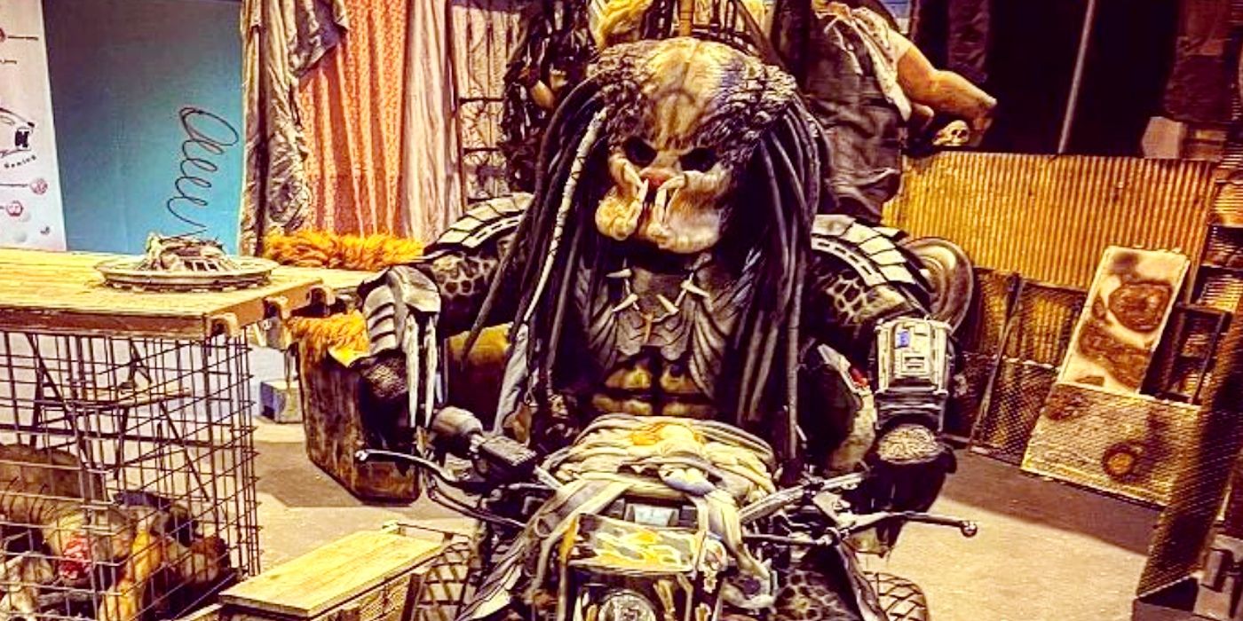 Predator cosplayer poses on a motorcycle.