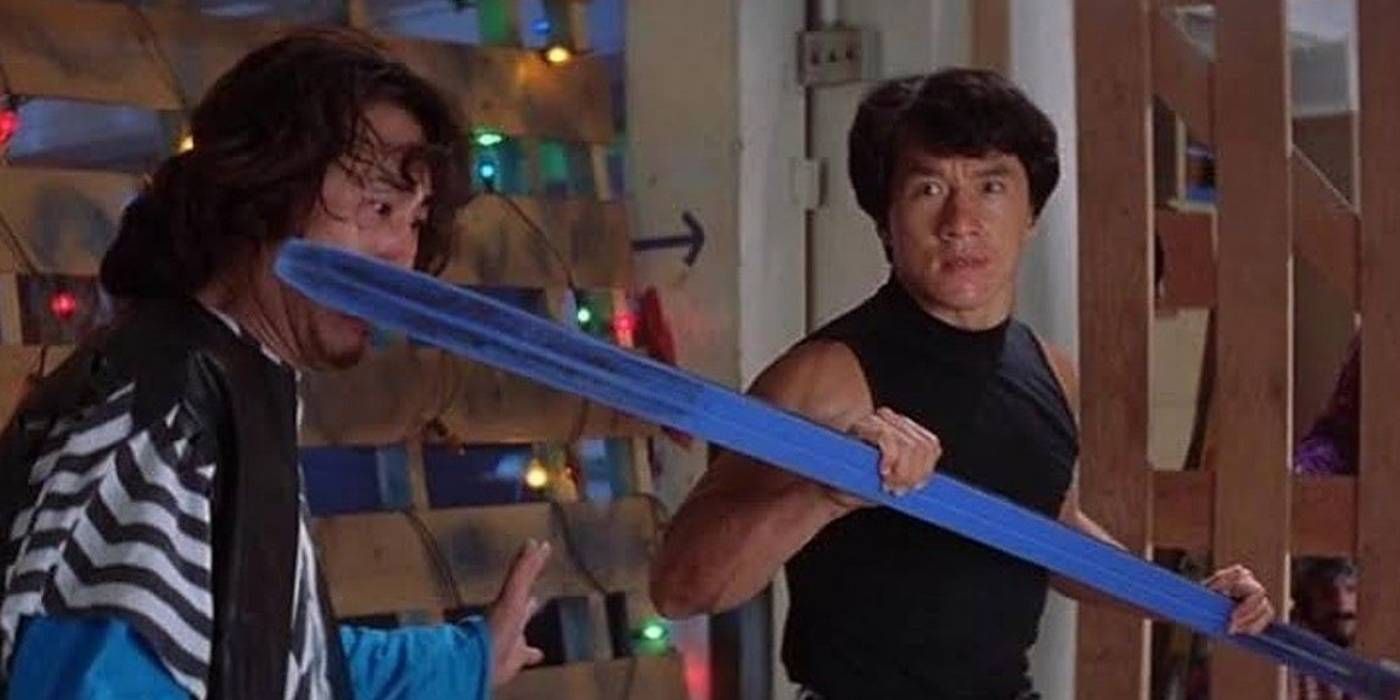 Jackie Chan as Ma Hon Keung hitting someone in the face with a blue pole in the movie Rumble in the Bronx