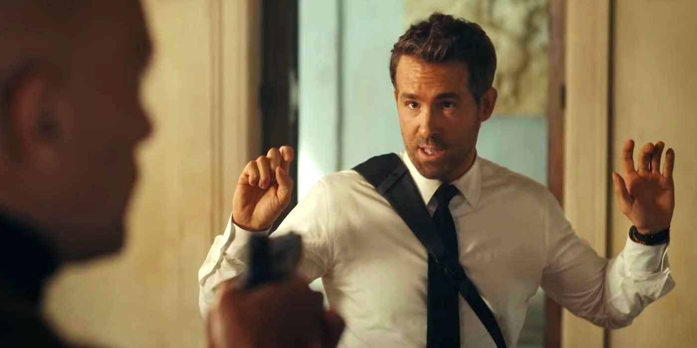 Ryan Reynolds with his hands up at gunpoint in Red Notice