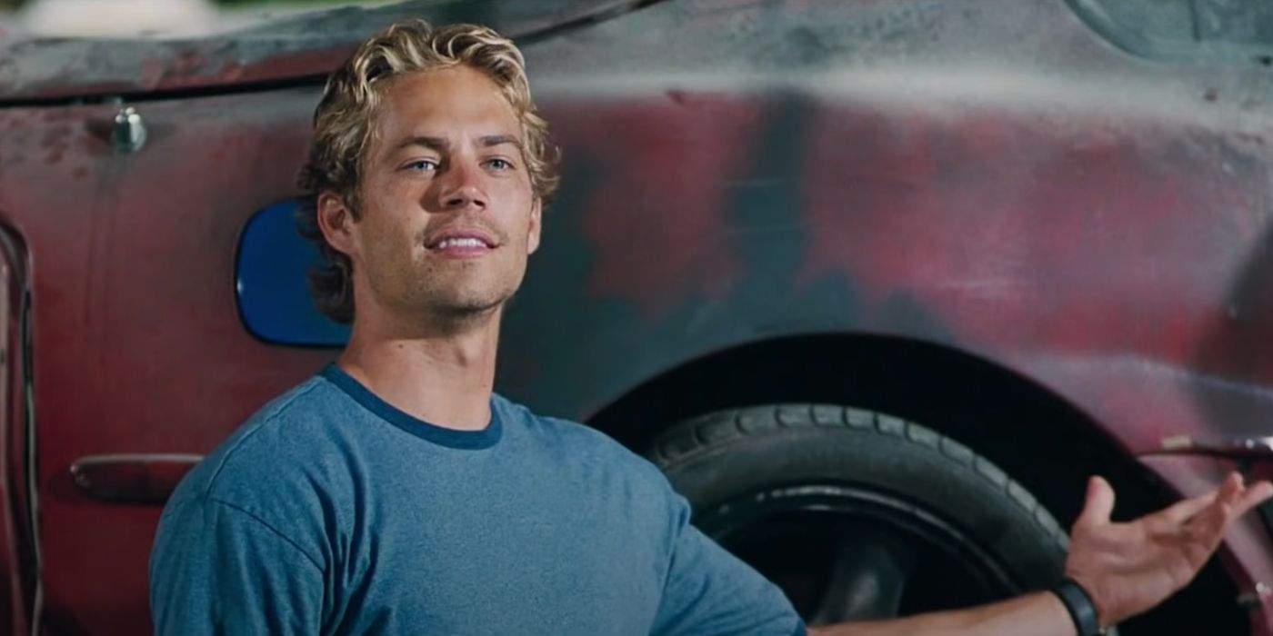 Paul Walker smiles in Dom's garage in The Fast and the Furious