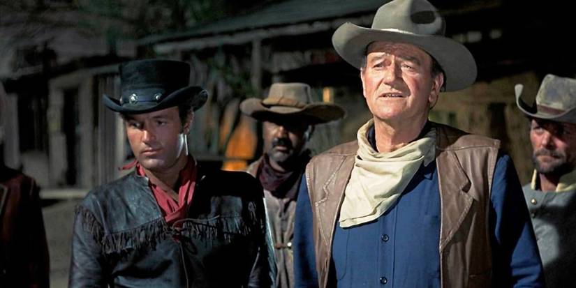 John Wayne and James Caan standing outside at night in El Dorado