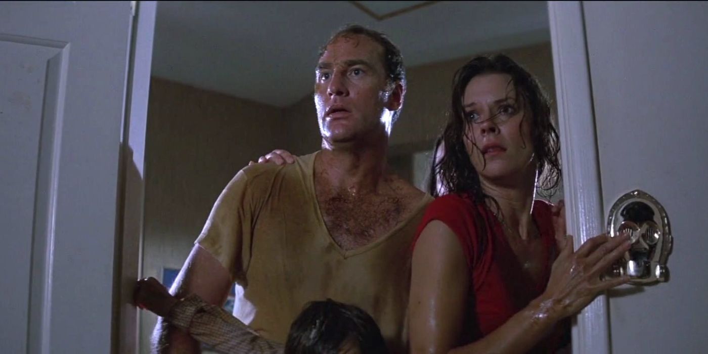 Steve and Diane Freeling covered in dirt and looking terrifed into a door.