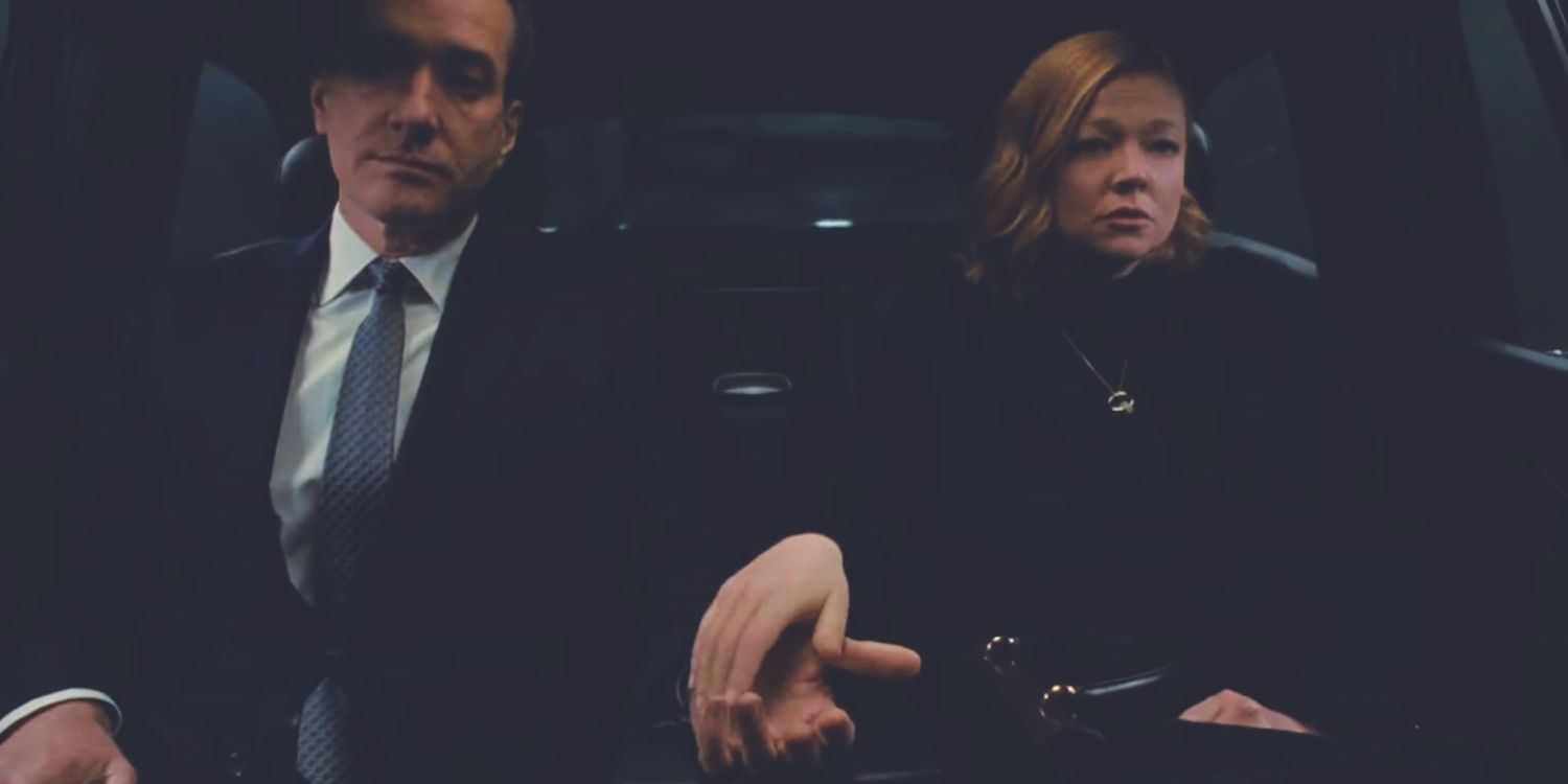 Shiv (Sarah Snook) and Tom (Matthew Macfadyen) coldly holding hands in the car in the ending of Succession