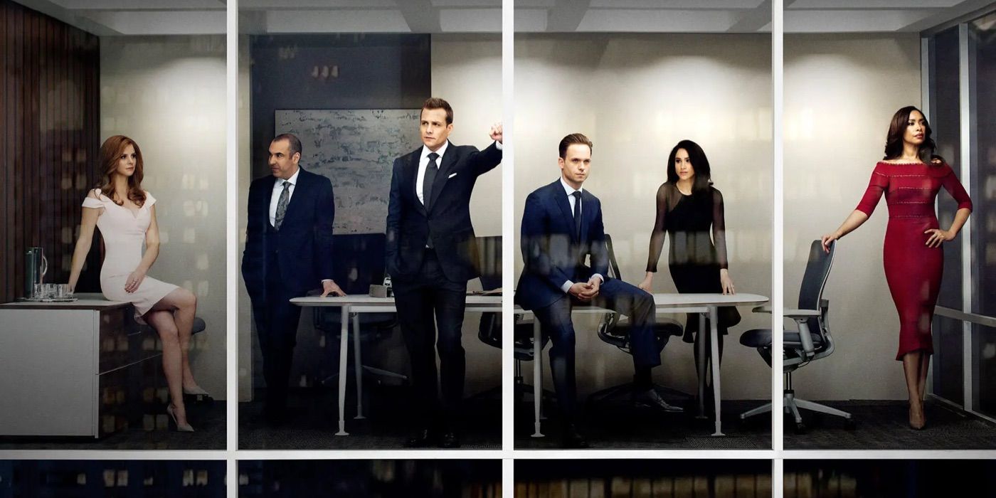 The cast of Suits as seen through an office window.