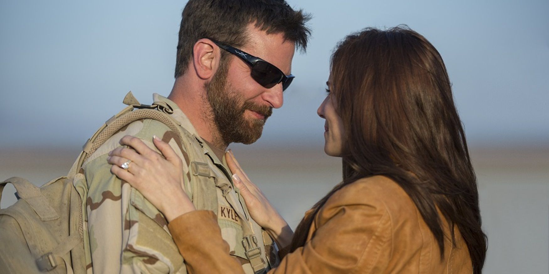 Sienna Miller as Taya embraces Chris in American Sniper.