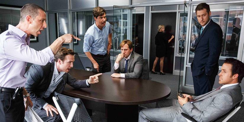 Several men yelling at Ryan Gosling's Jared Vennett in a board room in The Big Short