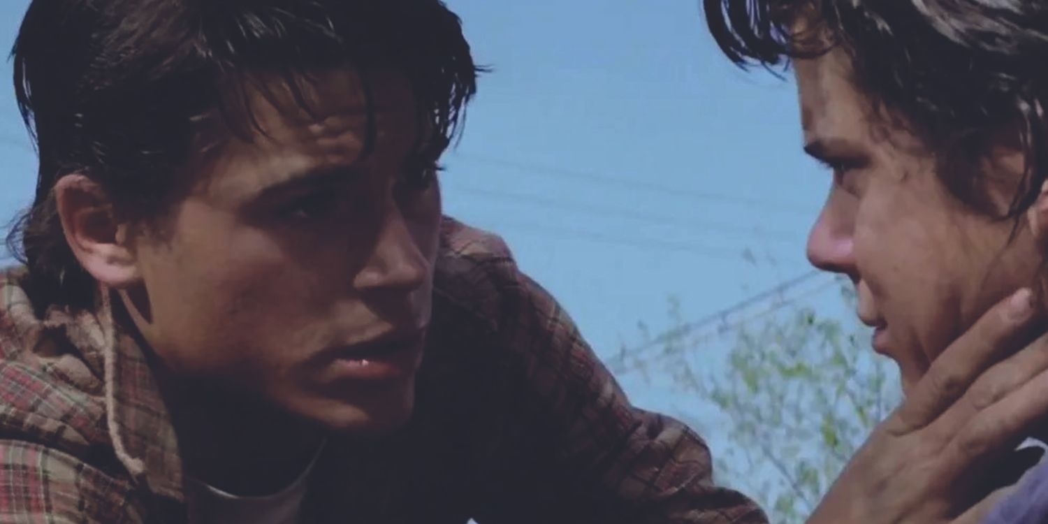 Rob Lowe as Soda Pop comforting C. Thomas Howell as Pony Boy in The Outsiders