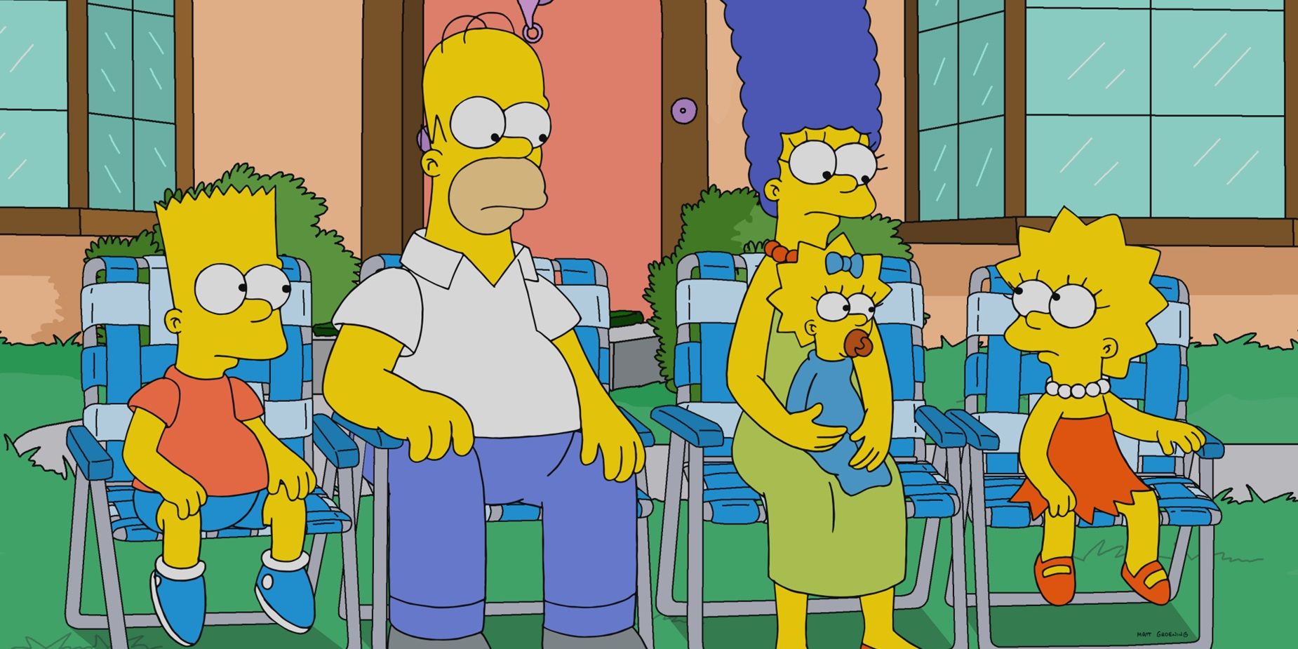 The Simpsons sitting on their front lawn